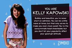 a woman with long dark hair wearing a purple crop top and floral print shorts, standing in front of a blue background that says you are kelly kapowski