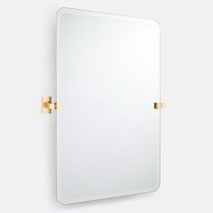 a bathroom mirror with two brass handles on the front and back of it, against a white wall