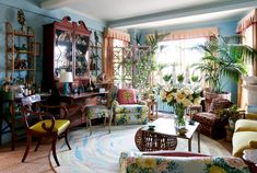 a living room filled with furniture and lots of plants