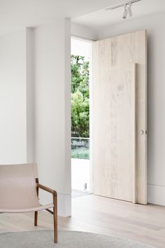 a chair sitting in front of a wooden door