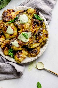 a white plate topped with brussel sprouts covered in powdered sugar