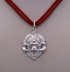 Amulet Style Jewelry For Puja And Festivals, Amulet Jewelry For Puja And Festivals, Silver Amulet Pendant Temple Necklace, Silver Amulet Pendant Necklace, Silver Jewelry For Puja During Navratri, Silver Jewelry For Navratri Puja, Silver Amulet Jewelry For Diwali, Navratri Ritual Amulet Jewelry, Silver Temple Necklace For Puja