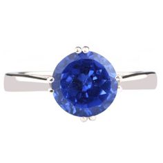 a blue sapphire ring on a white background