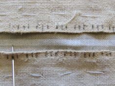 two pieces of fabric that have been stitched together, with some stitches on them