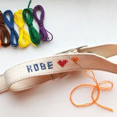 a pair of scissors sitting on top of a table next to some colorful thread and yarn