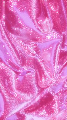 the fabric is shiny and pink with some sparkles on it's surface, as if