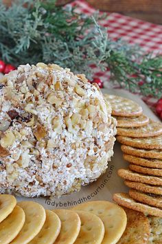 a cheese ball is surrounded by crackers and cranberries