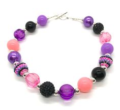 "Lightweight handcrafted 19\" necklace punches up any outfit.  Acrylic and metal beadwork accents your wardrobe with creativity and color.  Sophisticated purple, pink, black, and silver is both classic and contemporary.  Refresh that outfit and make it new again!" Trendy Purple Round Bead Necklace, Trendy Purple Round Bead Necklaces, Trendy Purple Beaded Necklace, Trendy Purple Necklace With Round Beads, Trendy Purple Adjustable Necklace, Trendy Adjustable Purple Necklace, Purple Beaded Necklace With Large Beads For Party, Pink Beaded Necklaces For Party, Pink Round Beaded Necklaces For Party