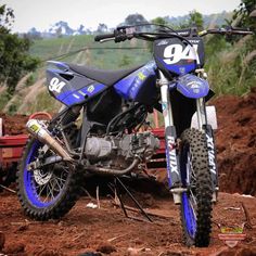 a dirt bike parked on top of a dirt field