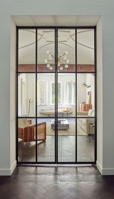 an open glass door leading into a living room