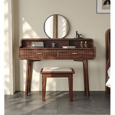 a wooden desk with a mirror and stool