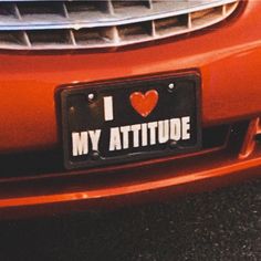 i love my attitude license plate on an orange car