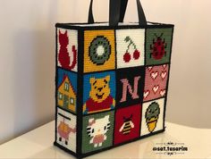 a bag made out of squares with animals and letters