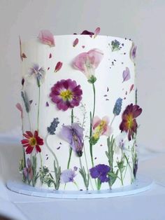 a white cake with flowers painted on it