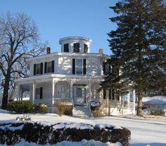 a large white house with snow on the ground