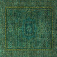 a green rug with an intricate design on the middle and bottom, surrounded by smaller squares