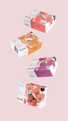 three boxes with different designs on them sitting in the middle of a pink background,