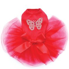 a dog wearing a red tutu with a butterfly on it