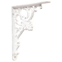 an ornate white shelf bracket on a white background