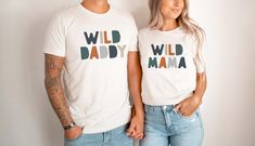 two people standing next to each other wearing t - shirts with the words wild daddy and mama printed on them