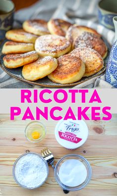 ricotta pancakes on a plate with powdered sugar and butter next to them,