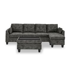 a gray couch and ottoman sitting next to each other