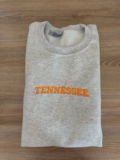 If you want a custom order or have any questions, please message me! -Tennessee embroidered crewneck -50/50 cotton/polyester -Unisex sizing: fits true to size. Order one size up for a looser fit. Custom Embroidery Crew T-shirt For College, Custom Embroidered Crew T-shirt For College, College Crew T-shirt With Custom Embroidery, Fan Apparel Cotton Sweatshirt With Embroidered Graphics, Custom Embroidery Crew Neck T-shirt For College, Team Spirit Embroidered Cotton Sweatshirt, Cotton Team Spirit Sweatshirt With Custom Embroidery, Gray Cotton Pre-shrunk Sweatshirt, Team Spirit Cotton Sweatshirt With Embroidered Graphics