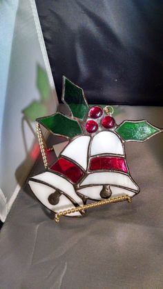 a stained glass christmas ornament sitting on top of a table