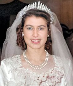 an old photo of a woman wearing a tiara and pearls on her wedding day