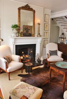 a living room filled with furniture and a fire place