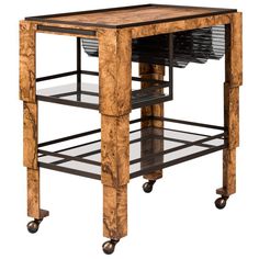 a wooden table with two shelves on wheels