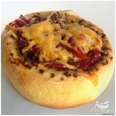 a pizza with cheese and chili on it sitting on top of a white countertop