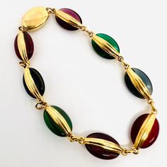 Beautiful Vintage Signed SWAROVSKI Multicolor Bezel Set Glass Disc Bracelet. Gold plated metal with multicolored jewel tone glass discs. Signed on clasp. In excellent vintage condition with minimal age appropriate wear. Measures 3/8 inch wide and is 8 inches long. Secure slide/box clasp Vintage Gold Glass Bracelets, Elegant Multicolor Metal Bracelet, Elegant Multicolor Metal Bracelets, Metal Bracelets With Multicolor Jeweled Details, Retro Multicolor Metal Bracelets, Disc Bracelet, Vintage Designer Jewelry, Jewel Tones, Bezel Setting