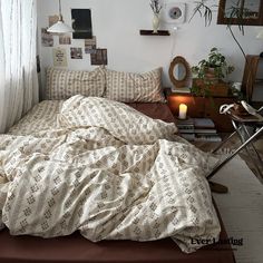 an unmade bed in a bedroom next to a window