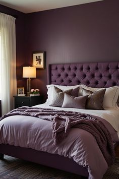 a bedroom with purple walls and a bed in the middle is decorated with throw pillows