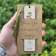 a hand holding a tag that says thank you for being pretty or sorry with a tassel hanging from it