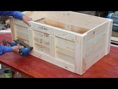 a man is working on a wooden box