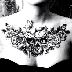 a woman with a skull and roses tattoo on her chest