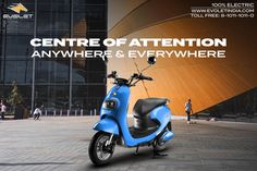 a blue scooter parked in front of a building with the words centre of attention anywhere and everywhere