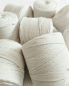 several spools of white twine sitting on top of each other