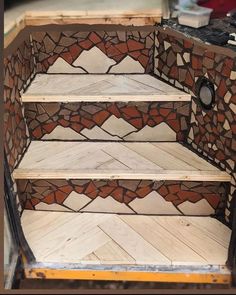 the steps are made out of wood and mosaic tiles