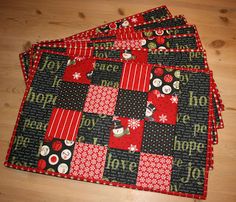 quilted placemats with red and black fabric on wooden table top next to wood floor