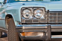 the front end of an old blue car