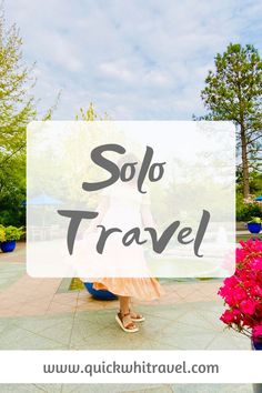 a woman standing in front of flowers with the words solo travel overlaying her