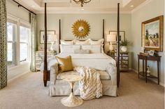 a bedroom with a large bed and chandelier hanging from it's ceiling