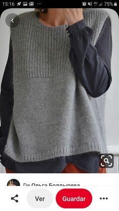 a woman wearing a gray and black sweater