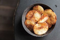 a bowl filled with fried food on top of a table