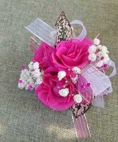 a pink and white corsage with flowers