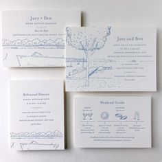 the wedding stationery is laid out on top of each other, with blue ink