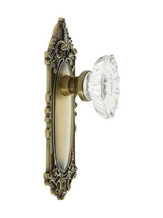 an antique brass door handle with glass knob